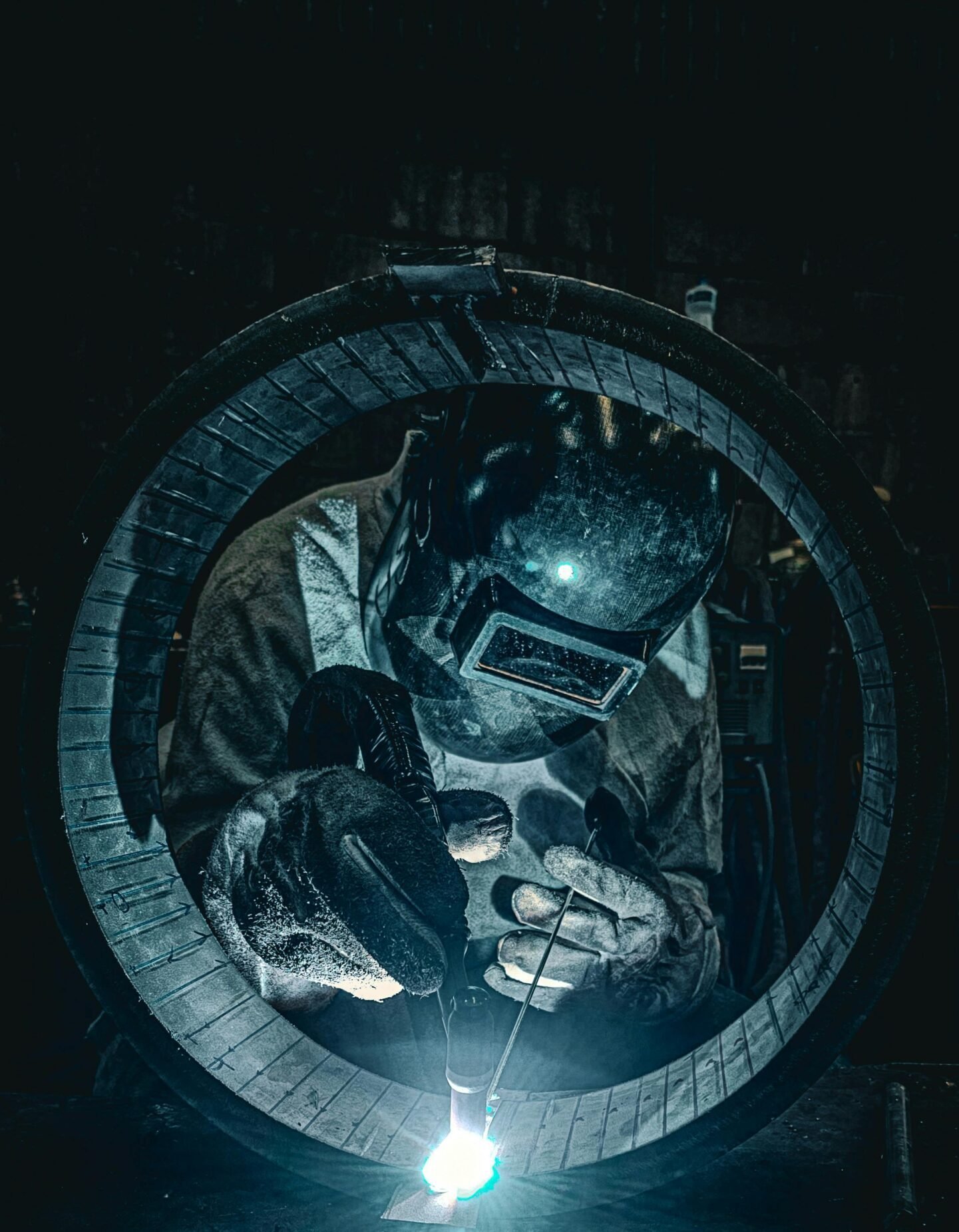 Professional welder at work in a Brazilian factory, showcasing intense precision and focus.